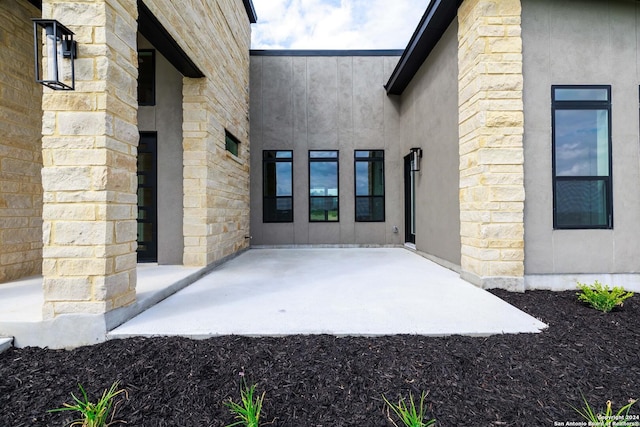 entrance to property with a patio