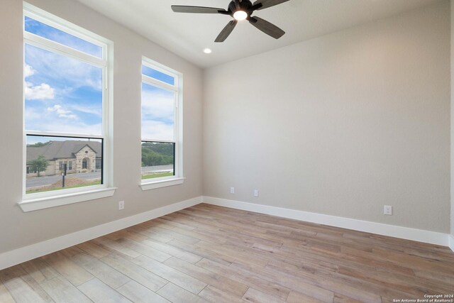 empty room featuring light wood-type flooring and ceiling fan