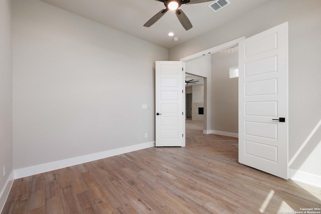 unfurnished bedroom with light hardwood / wood-style flooring and ceiling fan