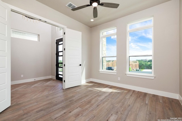 unfurnished room with ceiling fan and light hardwood / wood-style flooring