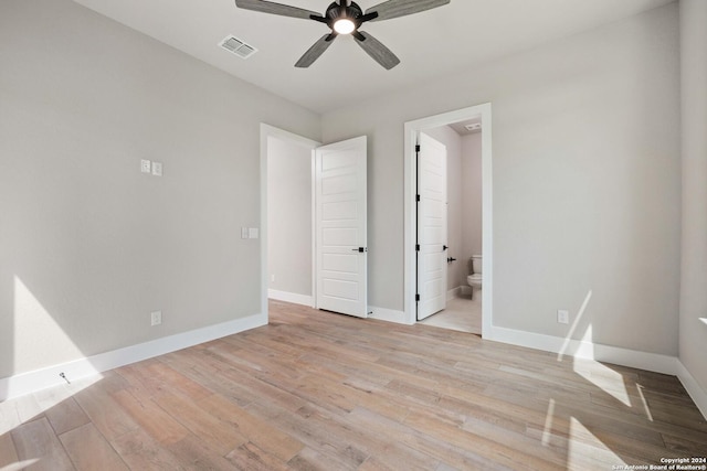 unfurnished bedroom with ceiling fan, light hardwood / wood-style floors, and ensuite bath