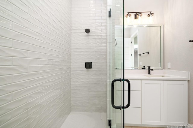 bathroom featuring vanity and a shower with shower door