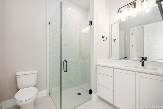 bathroom featuring toilet, vanity, tile patterned floors, and a shower with shower door