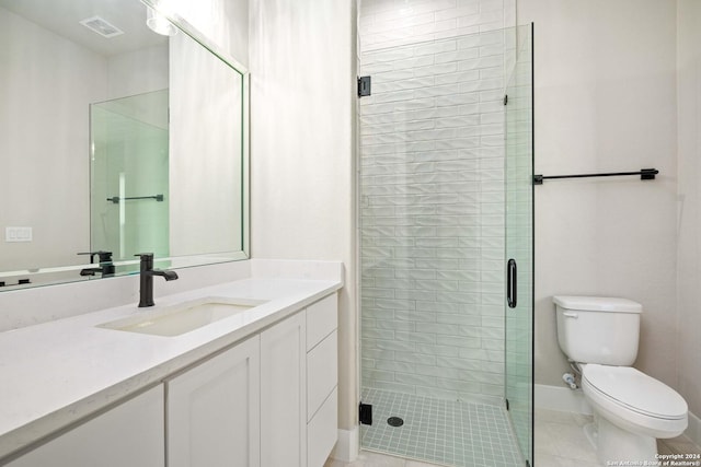 bathroom featuring tile patterned floors, vanity, toilet, and a shower with shower door