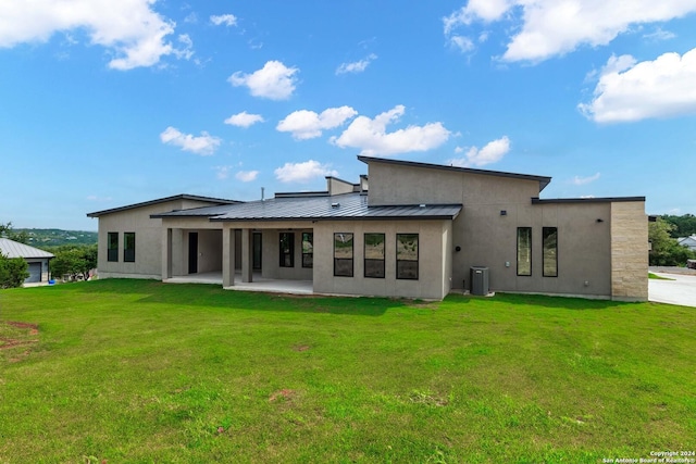 back of property featuring a lawn and a patio