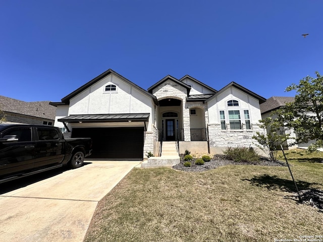 view of front of house with a garage and a front lawn