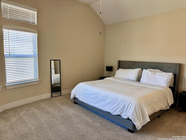 bedroom featuring carpet and lofted ceiling