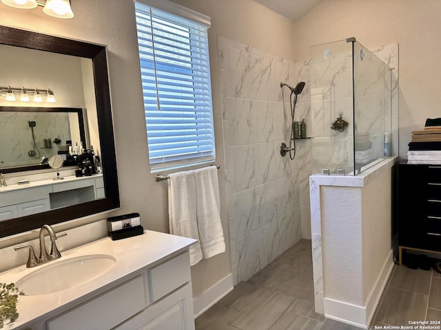 bathroom featuring vanity and tiled shower