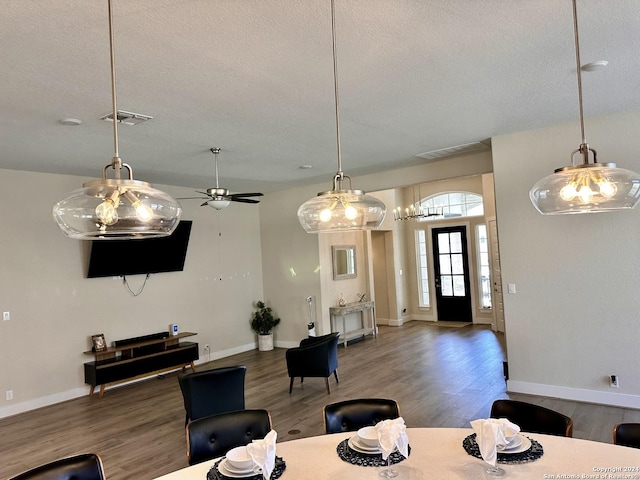 dining area featuring ceiling fan, hardwood / wood-style floors, and a textured ceiling