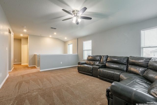 living room with ceiling fan, light colored carpet, and lofted ceiling