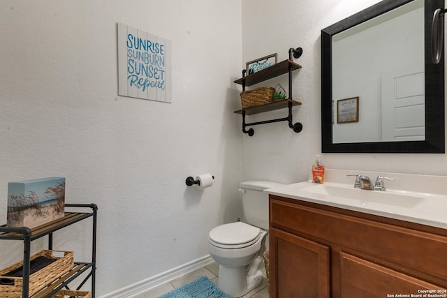 bathroom featuring tile patterned floors, vanity, and toilet