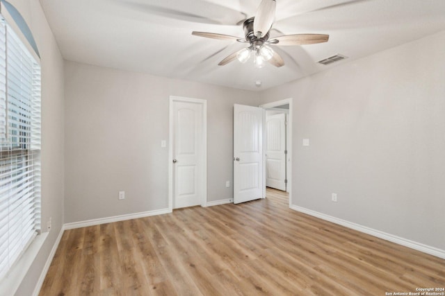 unfurnished bedroom featuring light wood-type flooring and ceiling fan