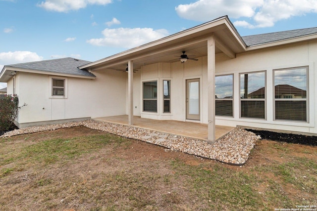 back of property with ceiling fan and a patio area