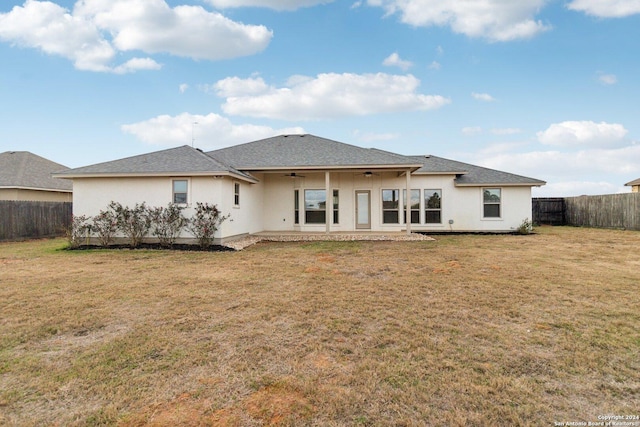 back of house with ceiling fan, a patio area, and a yard