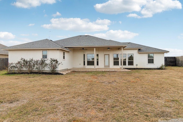 rear view of house with a patio area, ceiling fan, and a yard