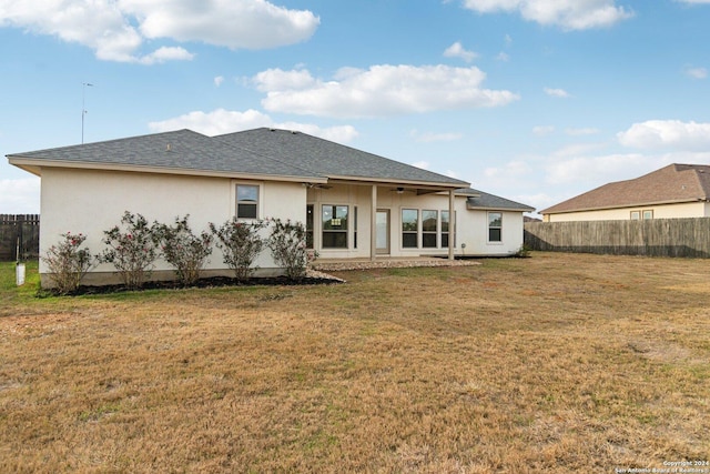 rear view of property with a yard and a patio