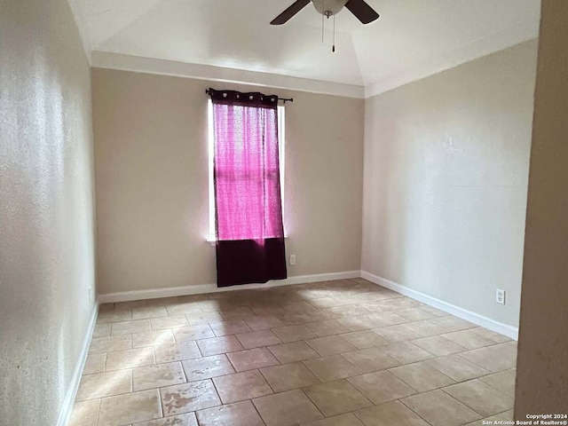 spare room with ceiling fan, light tile patterned floors, and lofted ceiling