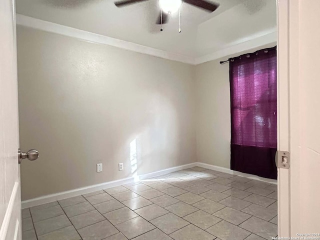 spare room featuring light tile patterned floors, ceiling fan, and crown molding