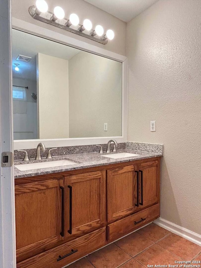 bathroom with tile patterned flooring and vanity