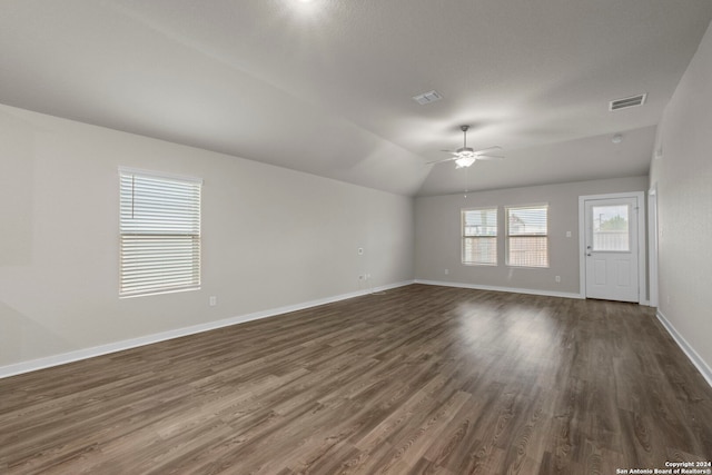 empty room with ceiling fan, dark hardwood / wood-style flooring, and lofted ceiling