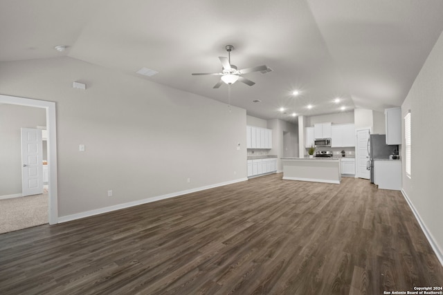 unfurnished living room with dark hardwood / wood-style floors, vaulted ceiling, and ceiling fan