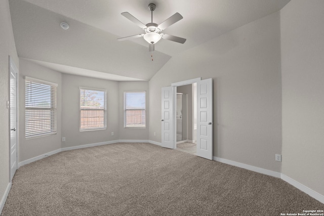 unfurnished bedroom featuring ceiling fan, light carpet, and vaulted ceiling