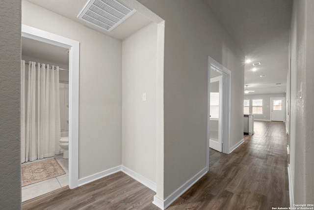 hall with dark hardwood / wood-style flooring