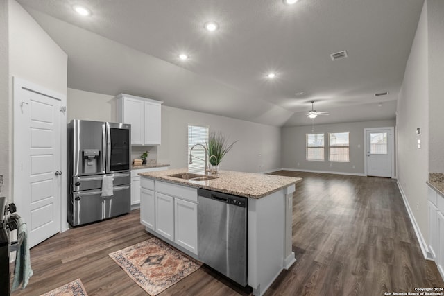 kitchen with white cabinets, stainless steel appliances, vaulted ceiling, and sink