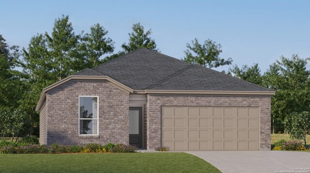 view of front of house featuring a front lawn and a garage