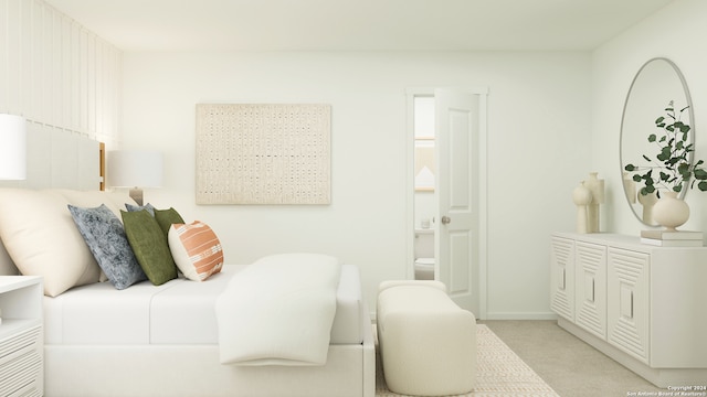 bedroom featuring light colored carpet and ensuite bath