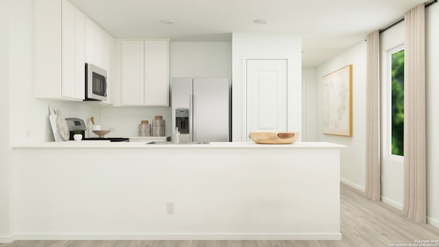 kitchen with white refrigerator with ice dispenser, kitchen peninsula, light hardwood / wood-style floors, white cabinets, and range