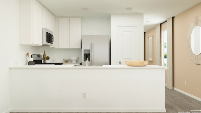 kitchen with kitchen peninsula, light wood-type flooring, white refrigerator with ice dispenser, white cabinets, and range