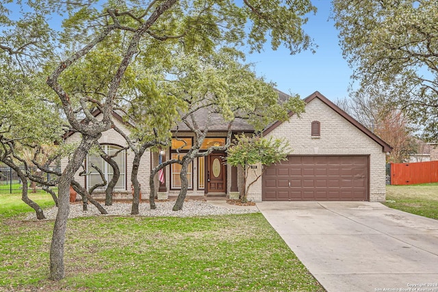 view of front of house featuring a garage and a front lawn