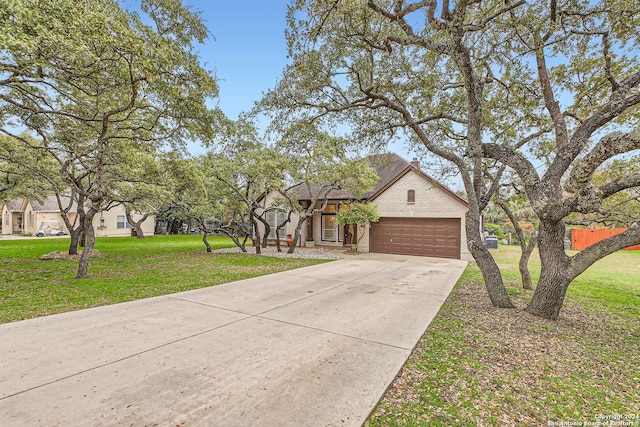 view of front of house with a garage and a front lawn