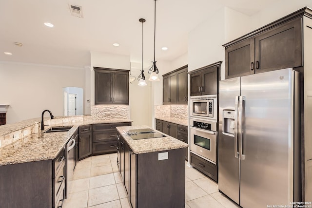 kitchen with sink, stainless steel appliances, kitchen peninsula, decorative light fixtures, and decorative backsplash