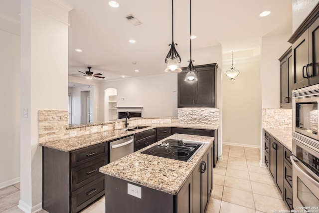 kitchen with ceiling fan, sink, hanging light fixtures, stainless steel appliances, and kitchen peninsula