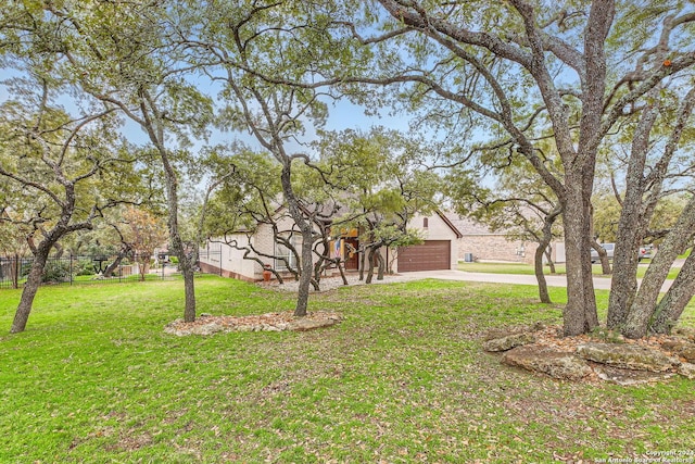 view of front of house with a front yard and a garage