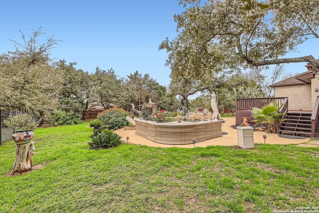 view of yard with an outdoor living space, a patio area, and a wooden deck