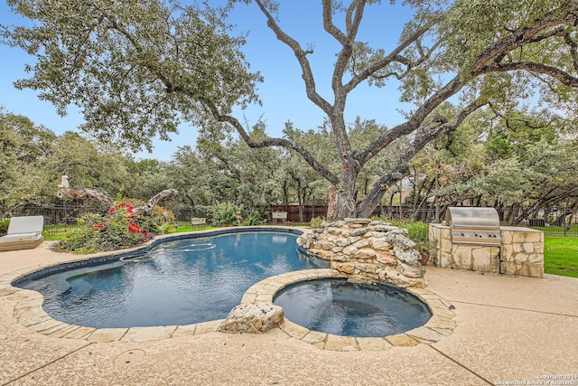 view of swimming pool featuring an in ground hot tub, area for grilling, and a patio area