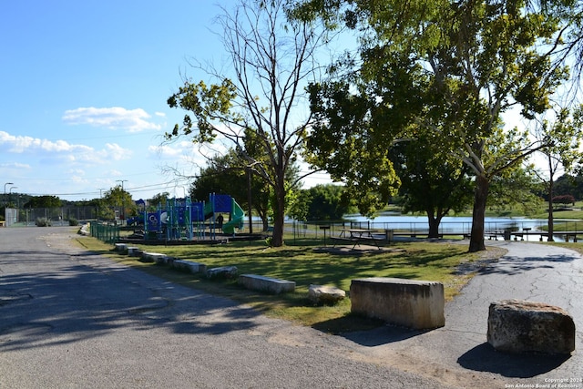 view of community with a water view and a playground