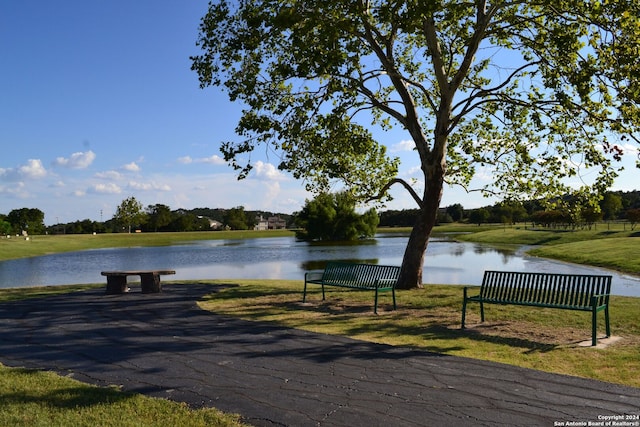 view of community with a yard and a water view