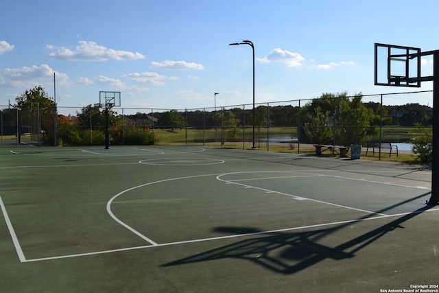 view of basketball court featuring a water view