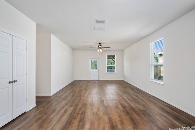 empty room featuring ceiling fan and dark wood-type flooring