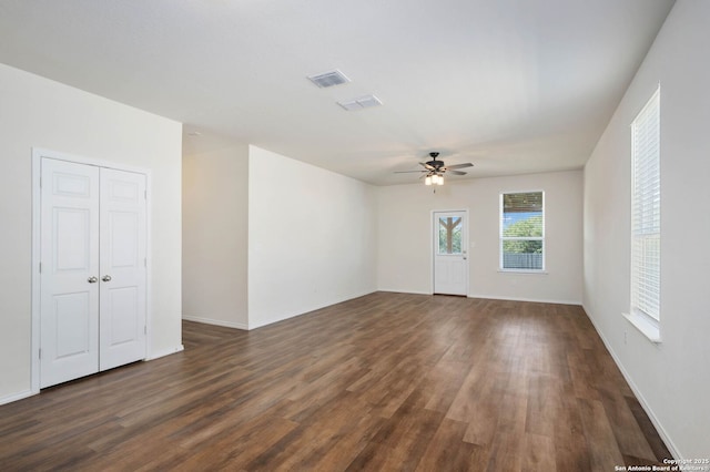 spare room with ceiling fan and dark wood-type flooring