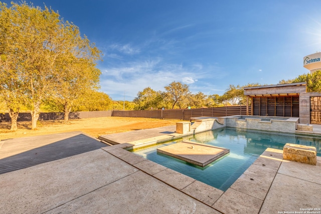 view of swimming pool with an in ground hot tub and a patio