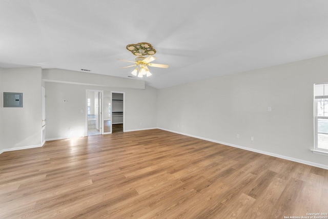 unfurnished living room with electric panel, ceiling fan, and light hardwood / wood-style floors