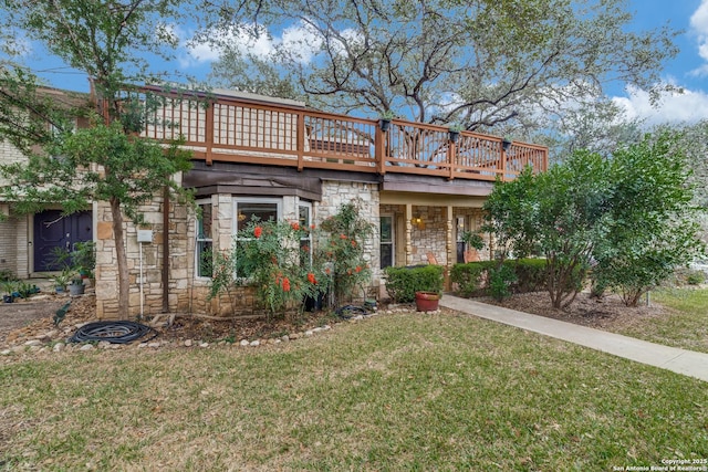 view of front of property featuring a front lawn and a deck