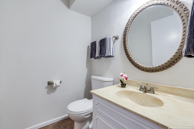 bathroom featuring a textured ceiling, toilet, tile patterned flooring, and vanity