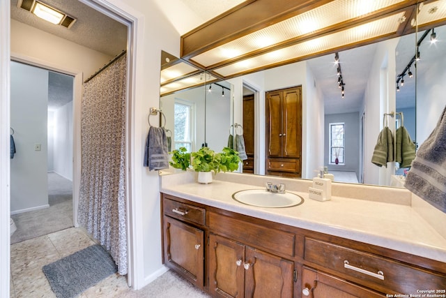 bathroom featuring a healthy amount of sunlight and vanity