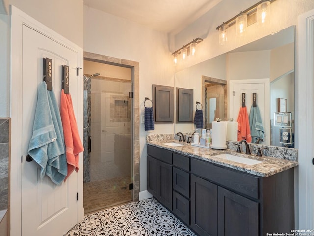 bathroom featuring tile patterned flooring, vanity, and a shower with door